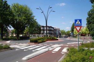 A photo of a road roundabout with physically separated cycle lanes to give cyclists priority and security